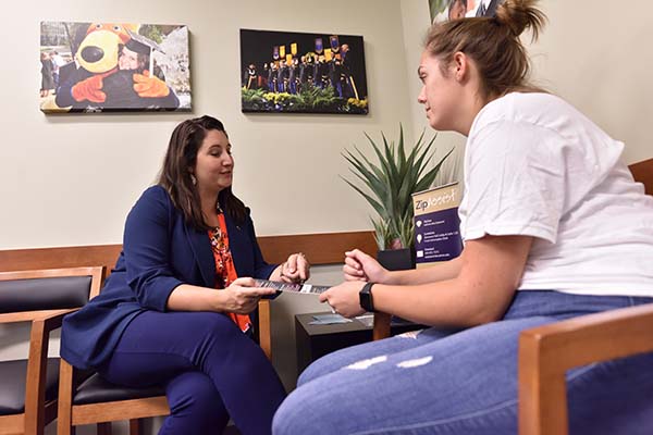 Social worker assisting female student.