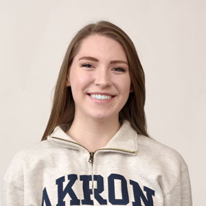 A female student wearing an Akron Zips sweatshirt