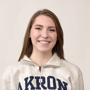 A female student wearing an Akron Zips sweatshirt