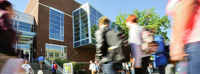 Students walk on campus during a tour.
