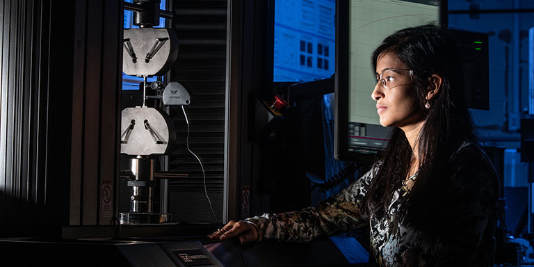 Graduate mechanical engineering student working on a project at The University of Akron