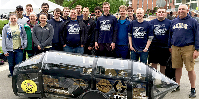 Mechanical Engineering students with Professor Sawyer and the human powered car they created at The University of Akron