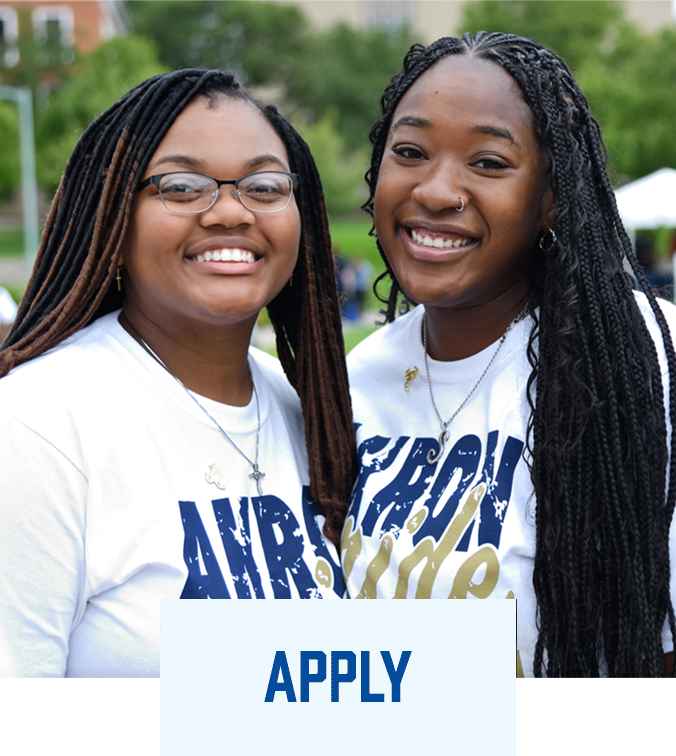 Two UA students smiling wearing Akron Pride T-shirts